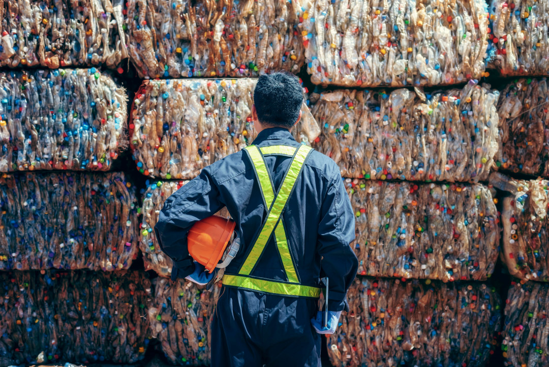 Man examining recycled plastic