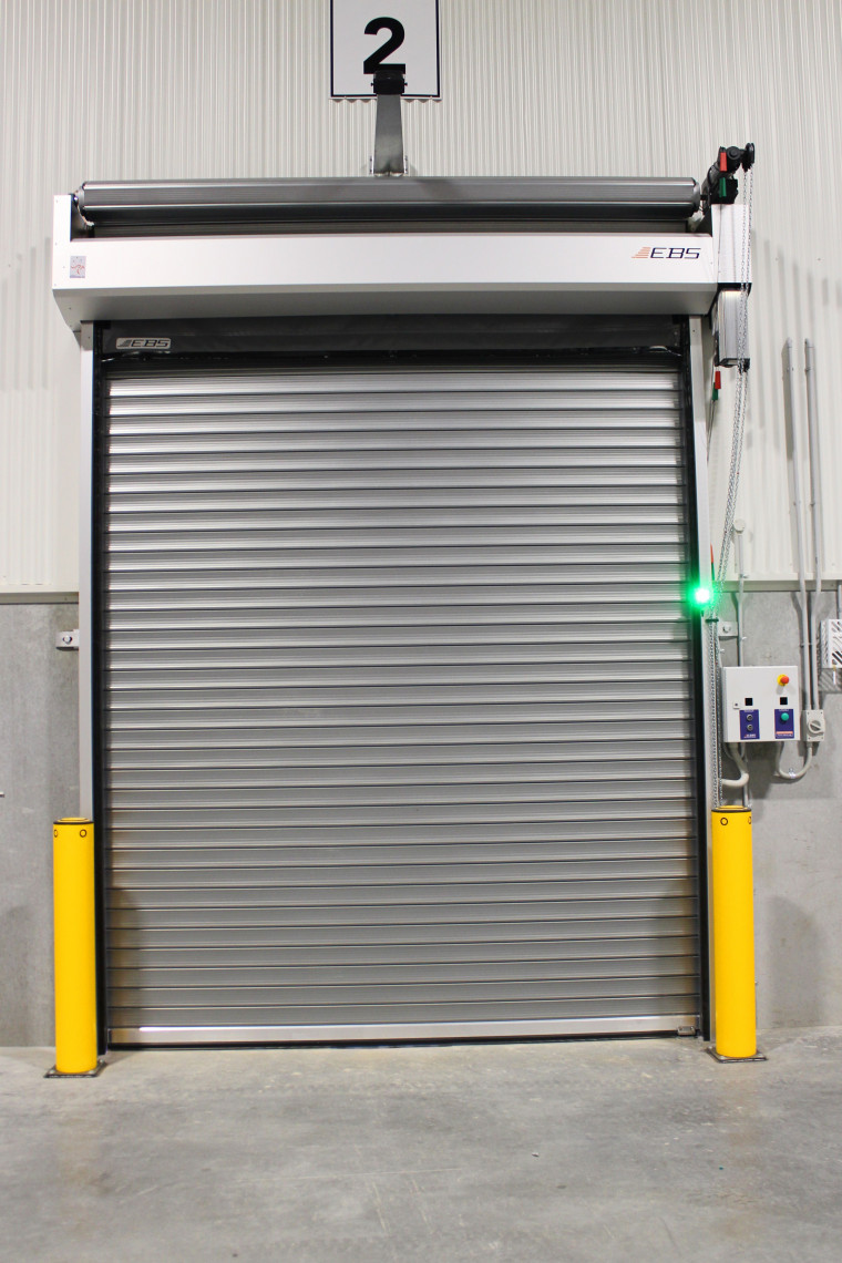 An integrated dual purpose insulated roller shutter combined with a PVC High Speed Door.